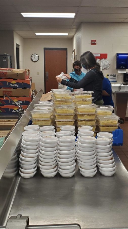 Staff prepare bags of chicken and dumplings for pick up